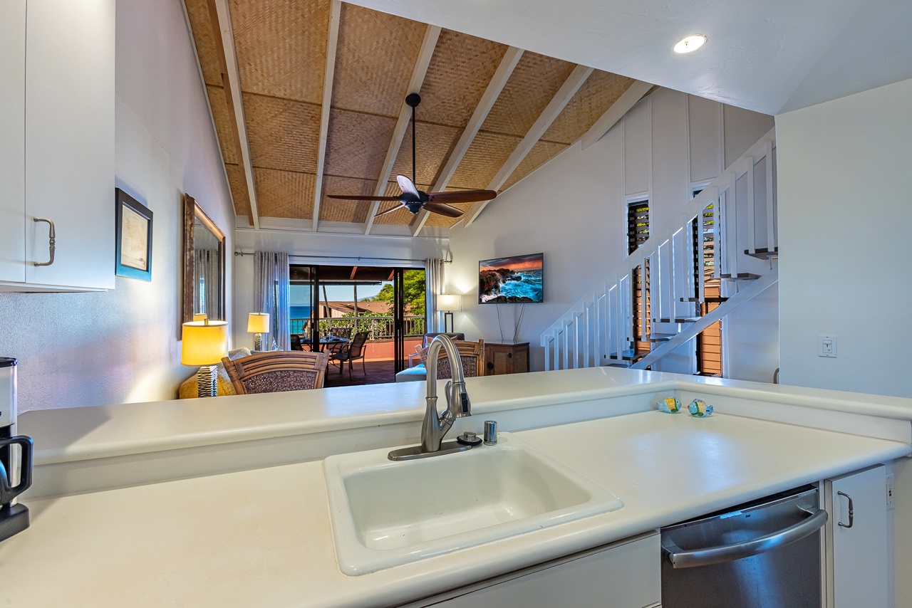 Relax in your bright, open living space with a soaring woven ceiling and glimpses of the sparkling sea through the patio doors beyond.