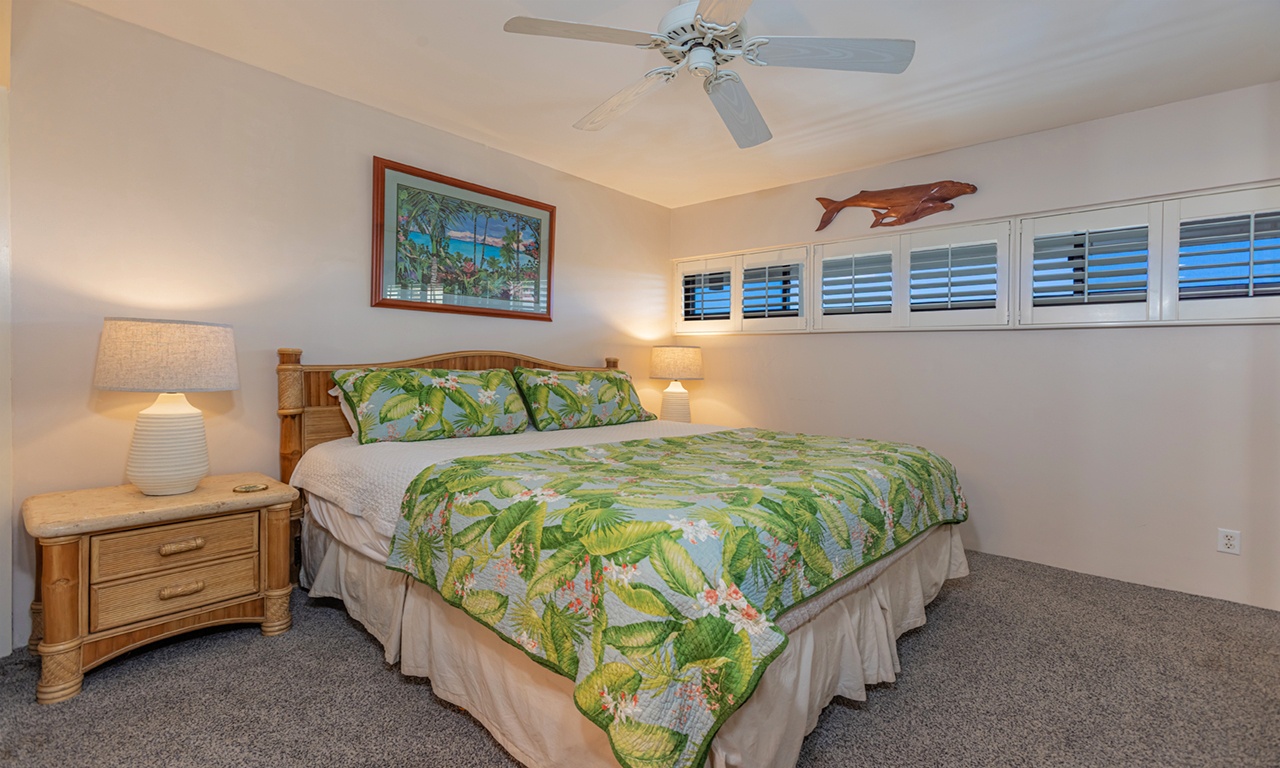 Cozy king bedroom with lush, tropical touches