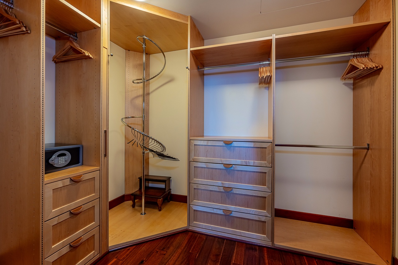 Organize your wardrobe with ease in this spacious custom closet. Ample hanging space, built-in drawers, and a convenient safe keep your belongings secure and accessible throughout your stay.