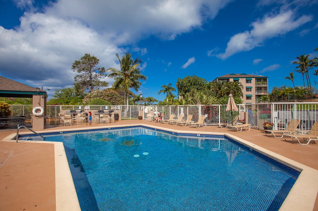 Sparkling swimming pool with tropical surroundings and comfortable lounging area for relaxing under the Hawaiian sun.