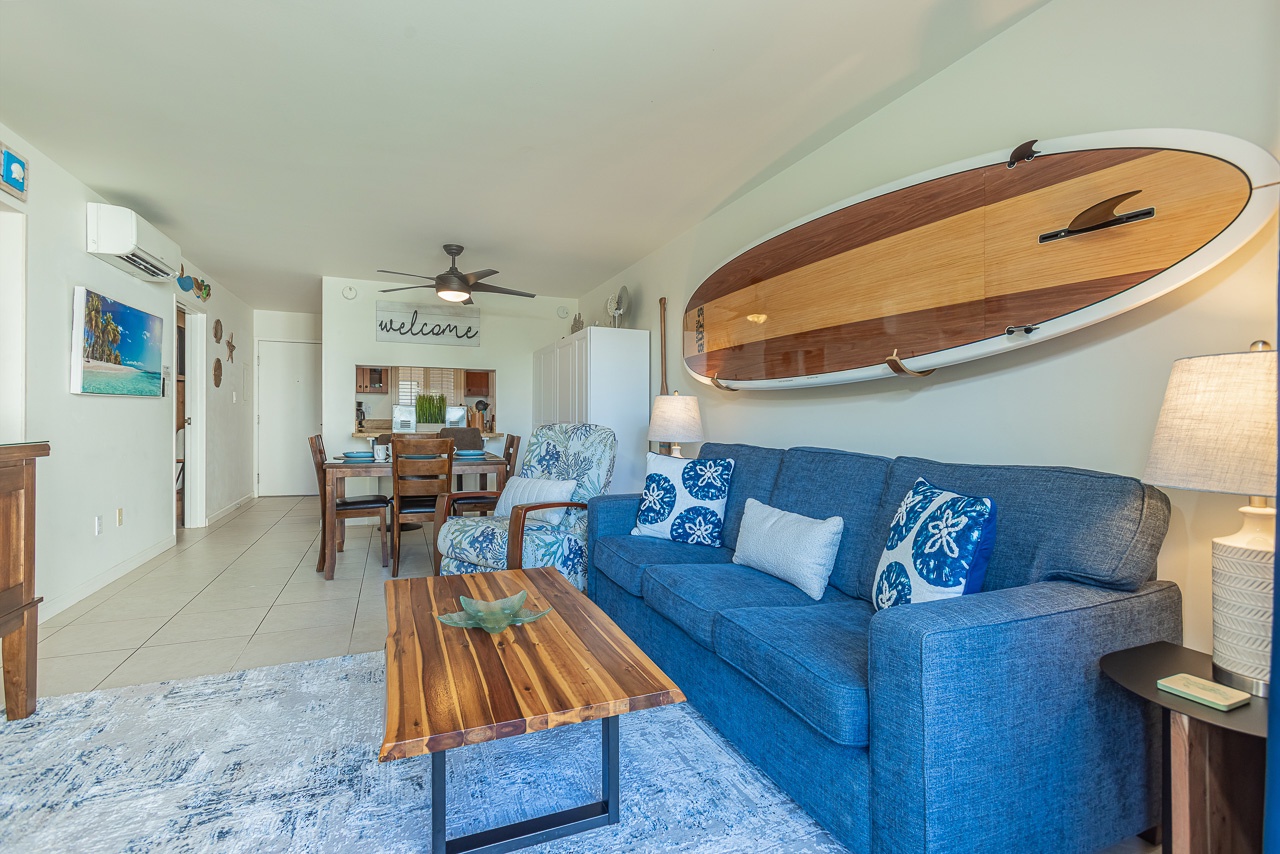 Relax in your coastal-inspired living space with ocean-blue furnishings and surfboard art that capture the beachside spirit.
