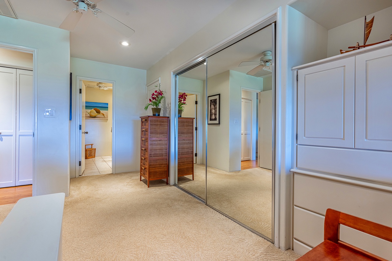 Your spacious bedroom features clean coastal colors, generous mirrored closets, and warm wood accents that create a serene retreat.