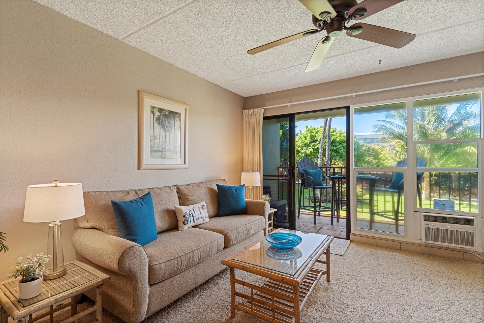 Unwind on your comfortable sofa while enjoying lush garden views through floor-to-ceiling windows. A ceiling fan keeps you cool as you sip your morning coffee and plan your day.