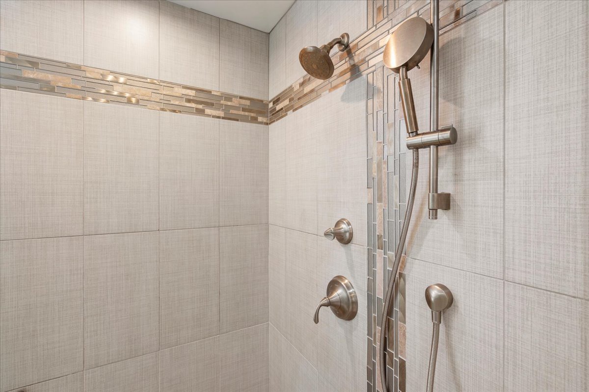 Relax in the refreshed primary bathroom with modern finishes