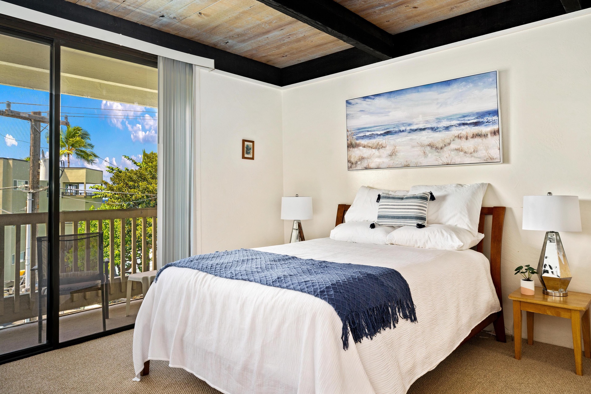 Wake up to tropical breezes and sunshine streaming through your private balcony doors. Sink into plush bedding under coastal-inspired art, and let the island's warmth embrace your perfect vacation escape.