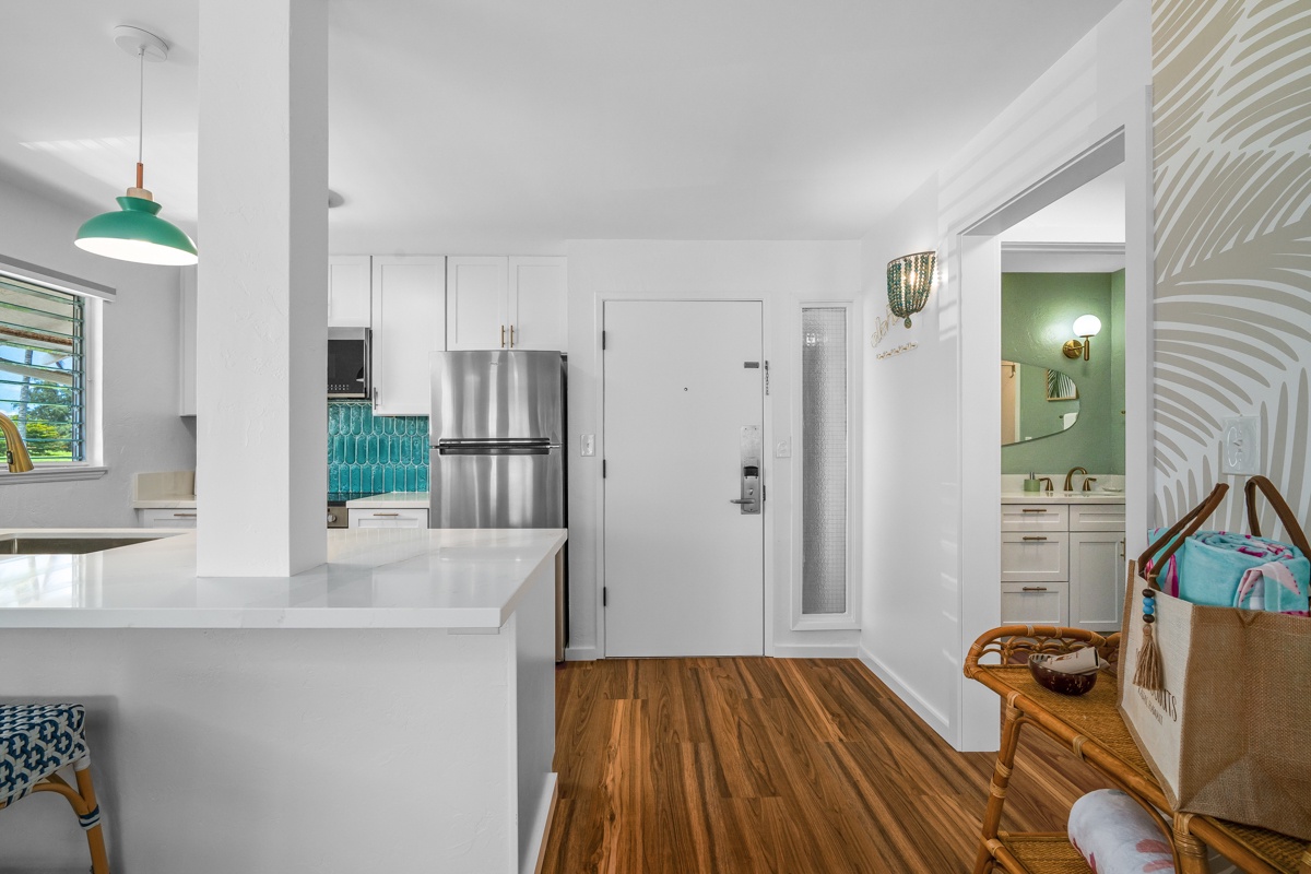 Step into your bright, welcoming retreat with a fully-equipped kitchen featuring turquoise accents, warm wood floors, and a coastal-inspired vibe that makes you feel instantly at home.