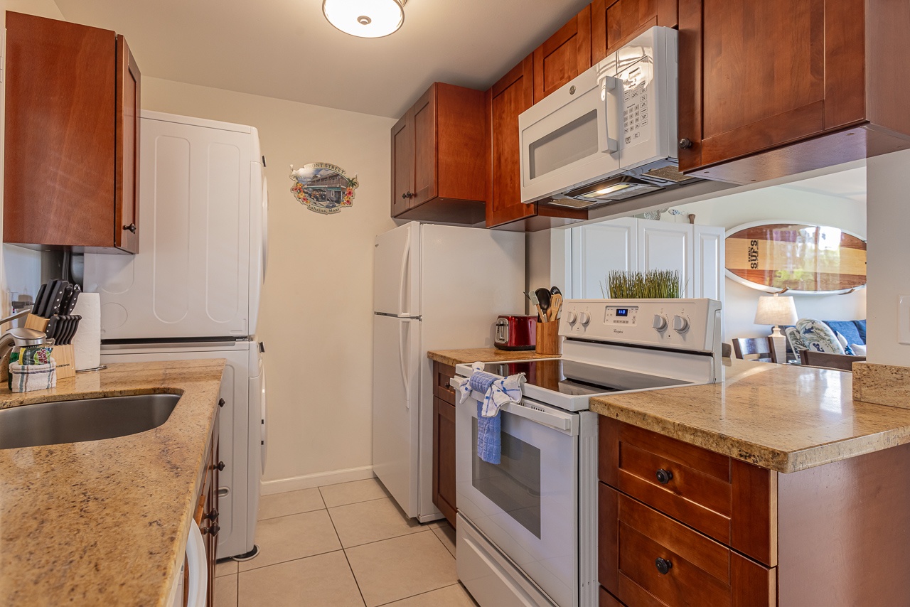 Your fully equipped kitchen features warm cherry cabinets, granite countertops, and modern appliances for all your culinary adventures.