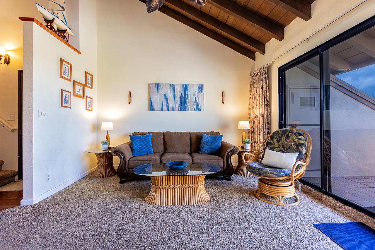 Sink into the plush sofa or rattan chair and unwind beneath vaulted wooden beam ceilings that add rustic warmth to your cozy retreat.