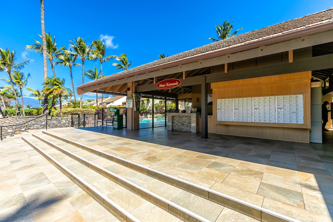 Office entrance featuring tropical palms under sunny Hawaiian skies.