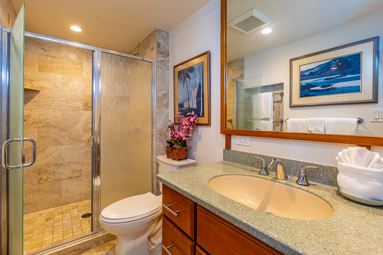 Walk in shower with glass door and panel to add visibility. 