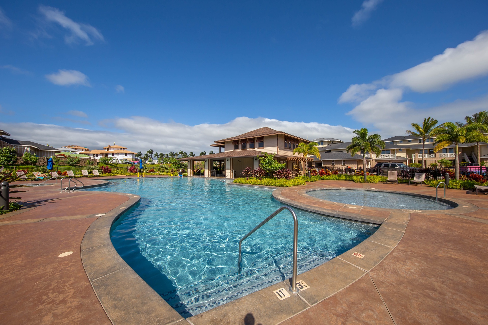 Resort-style community pool with tropical landscaping.