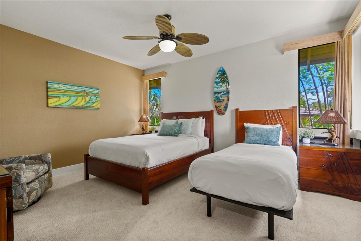 Your spacious retreat features two comfy beds with crisp linens, tropical artwork, and a ceiling fan to keep you cool. Relax in the armchair or admire the lush greenery through bright windows.