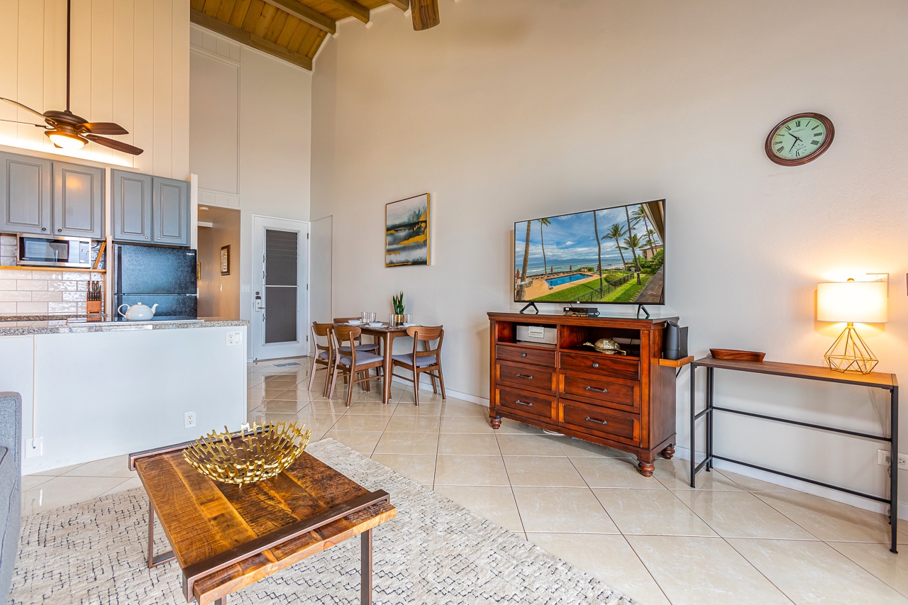 Unwind in your bright, open living space with vaulted wood-beam ceilings, a fully equipped kitchen, cozy dining nook, and tropical island views.