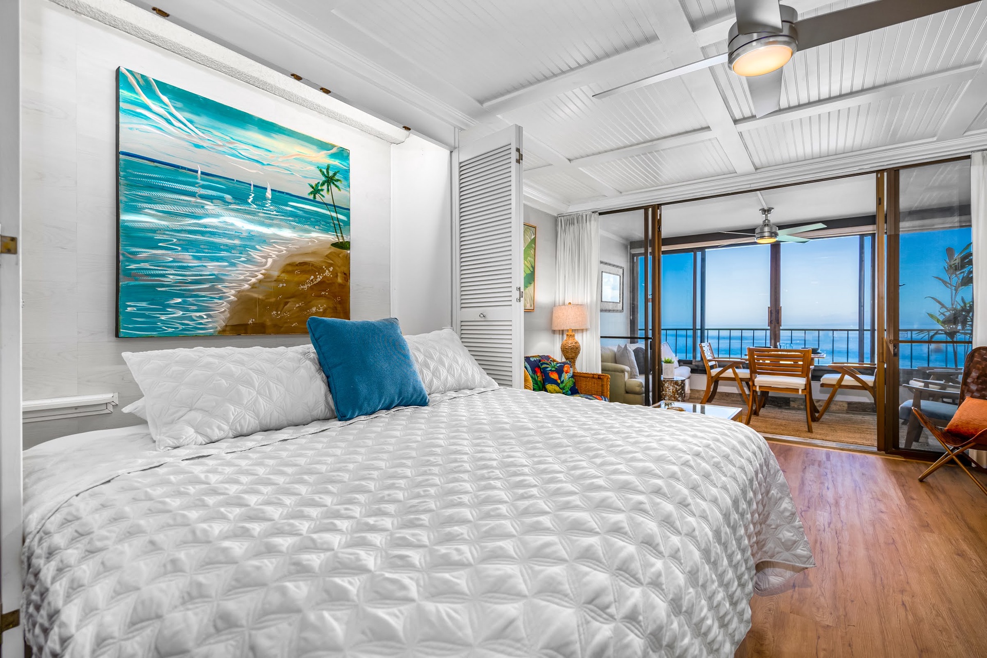 Wake to an ocean breeze in your bright coastal room, where soft white linens and warm wood floors set the stage for complete relaxation. Step through the sliding doors to your private balcony and greet endless blue horizons.