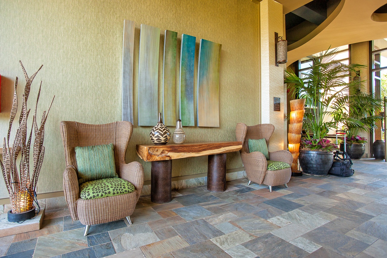 Settle into stylish comfort in this elegant lobby seating area, where tropical touches and warm earth tones create the perfect spot to unwind.