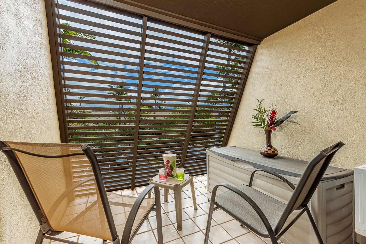 Unwind on your private balcony with a morning coffee or evening drink. Two comfortable chairs and a small side table create the perfect spot to relax while enjoying tropical breezes and peekaboo views through the louvered privacy screen.