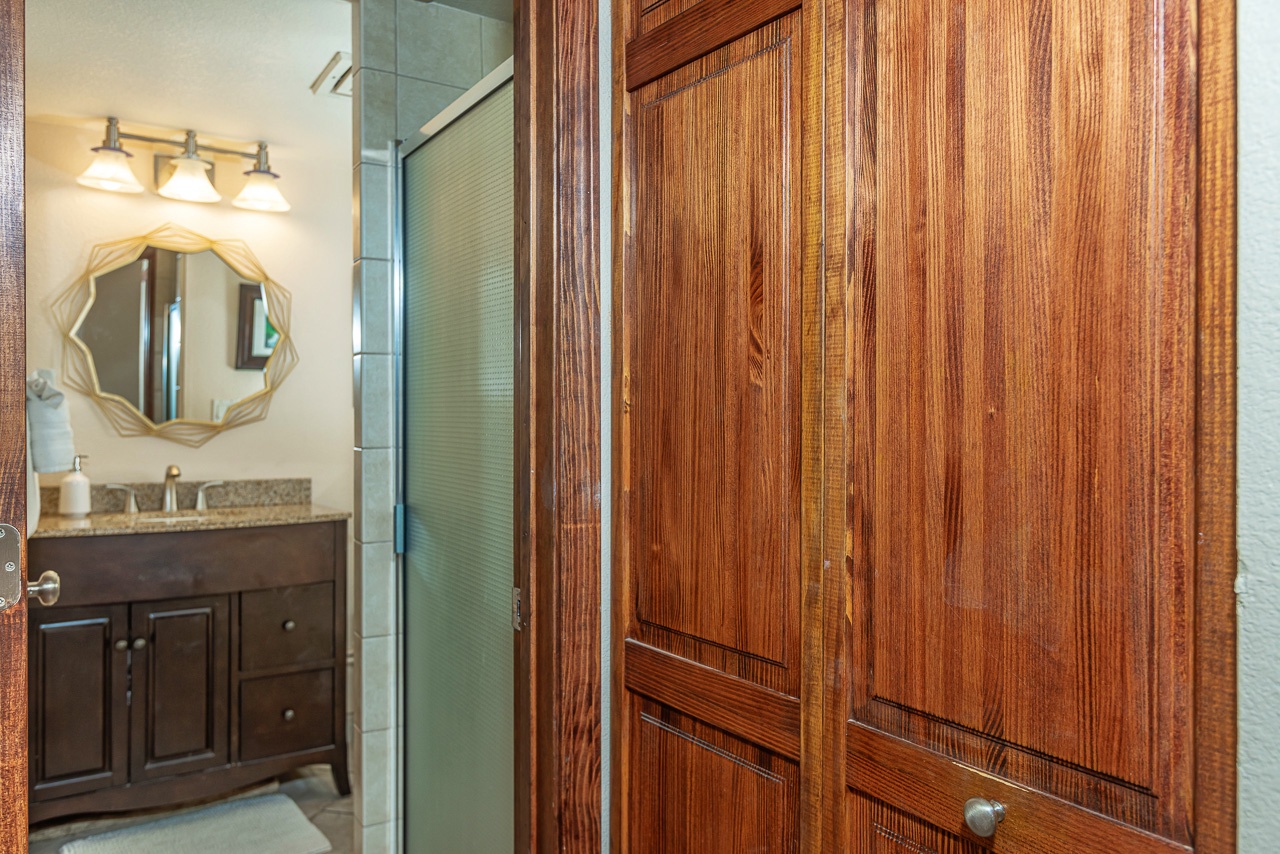 Step into your private bathroom, where warm wood tones and elegant fixtures create a welcoming retreat. The stylish vanity and soft lighting set the perfect tone for your morning routine.