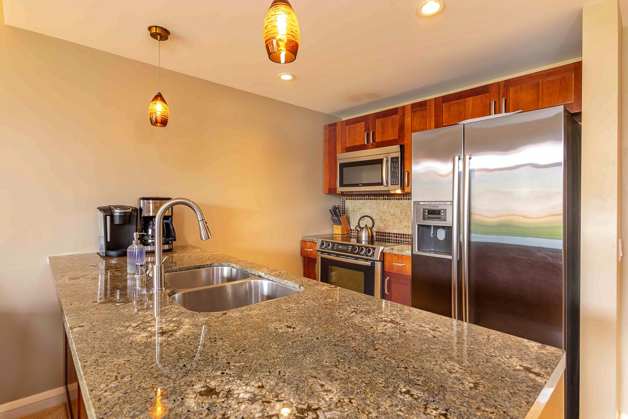 Step into your fully-equipped kitchen where gleaming granite counters and stainless steel appliances set the stage for vacation meals.