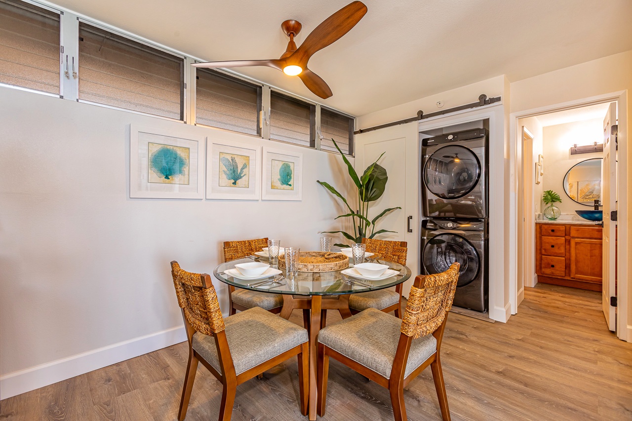 Gather around this inviting dining table for your morning coffee or evening meal, with coastal artwork setting a relaxed tone. A stacked washer and dryer nearby adds convenience to your stay.