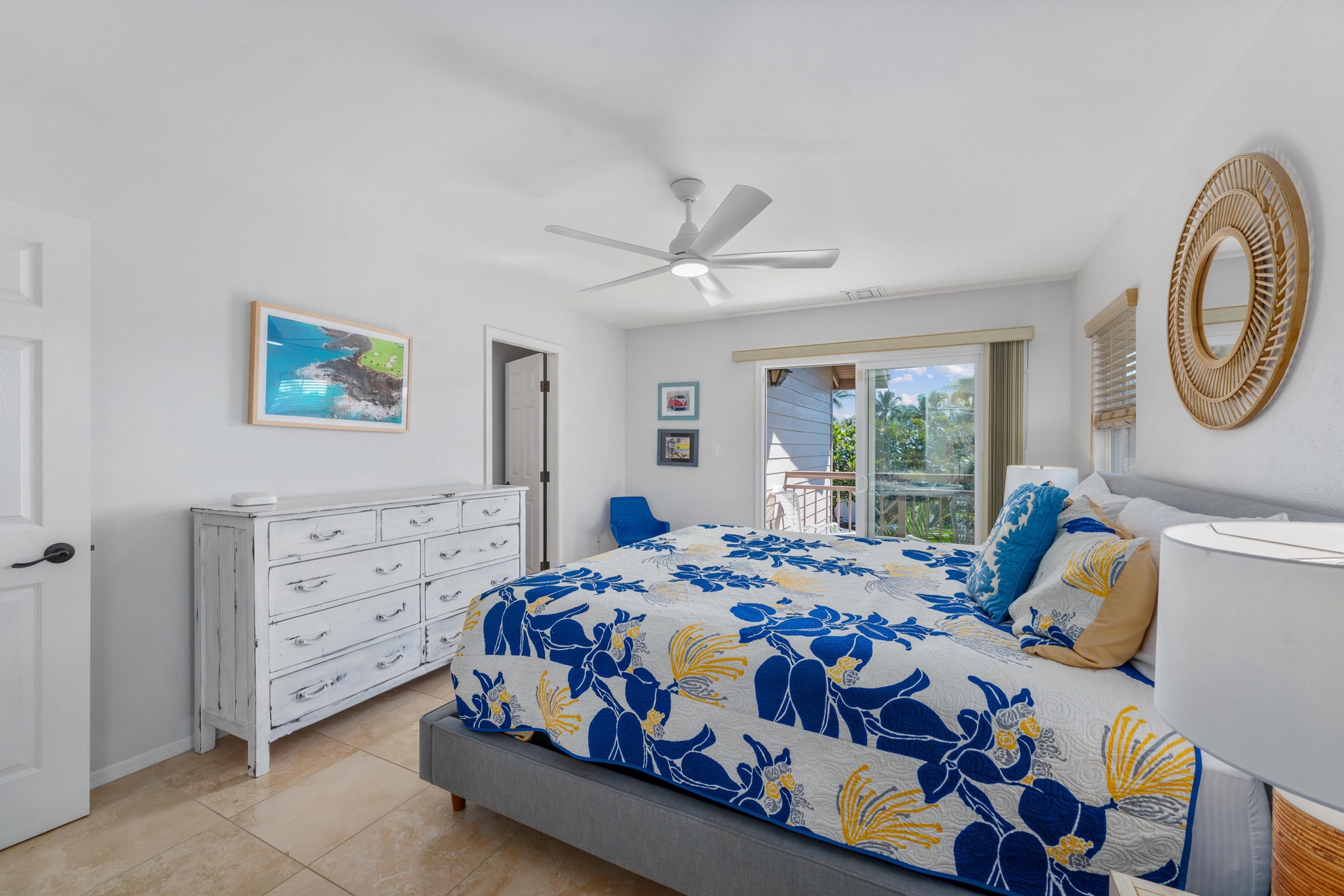 Drift off in your bright, airy bedroom with tropical blooms and cooling ceiling fan creating the perfect island sanctuary.