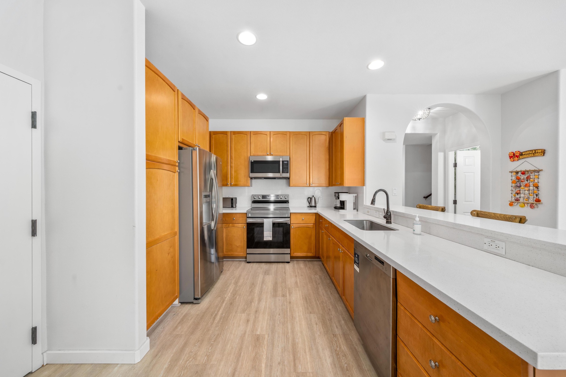 Your fully equipped kitchen awaits with warm wood cabinets, stainless steel appliances, and plenty of space to create memorable meals together.