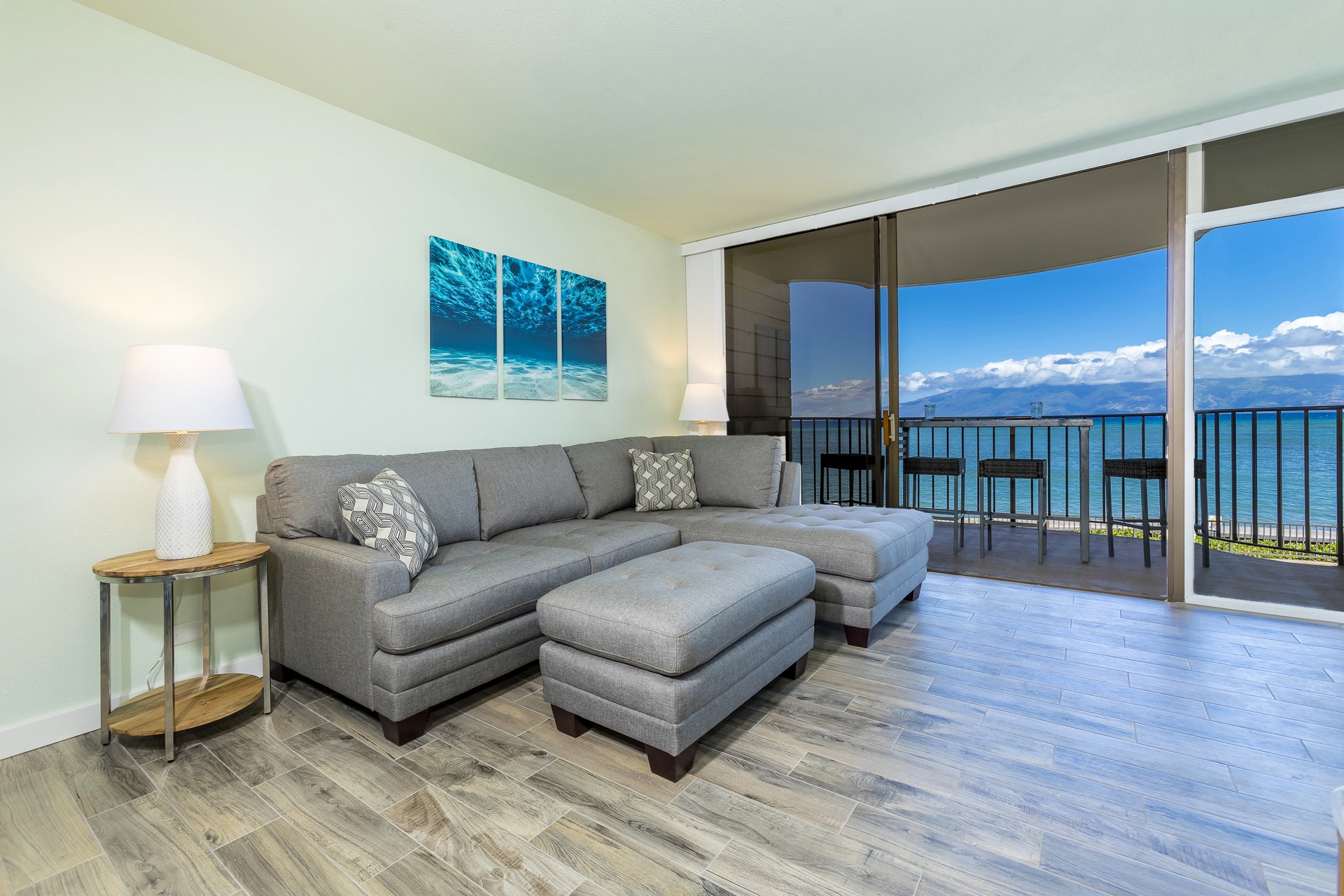 Sink into the plush sectional as ocean breezes drift across your private balcony, creating your perfect island sanctuary.