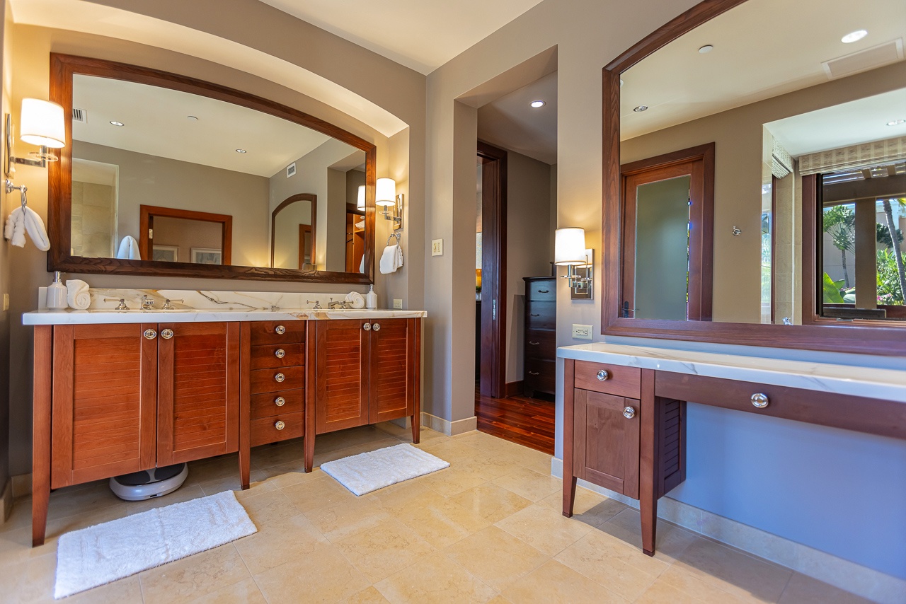Step into your spa-like bathroom with dual vanities, elegant marble countertops, and warm wood cabinetry that frames soft lighting for a relaxing retreat after a day of adventure.