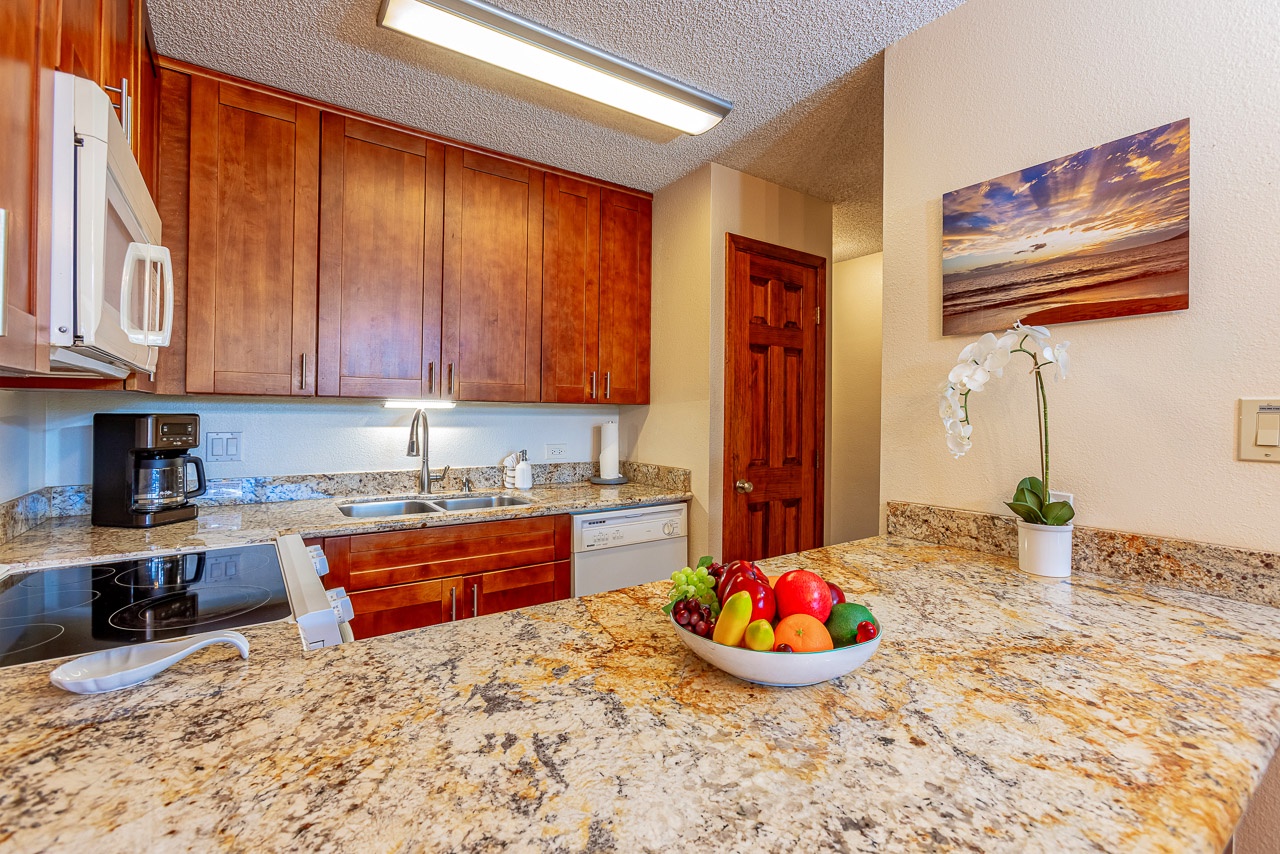Your fully equipped kitchen features gleaming granite counters, rich wood cabinetry, and modern appliances—everything you need to cook your favorite meals in comfort and style.