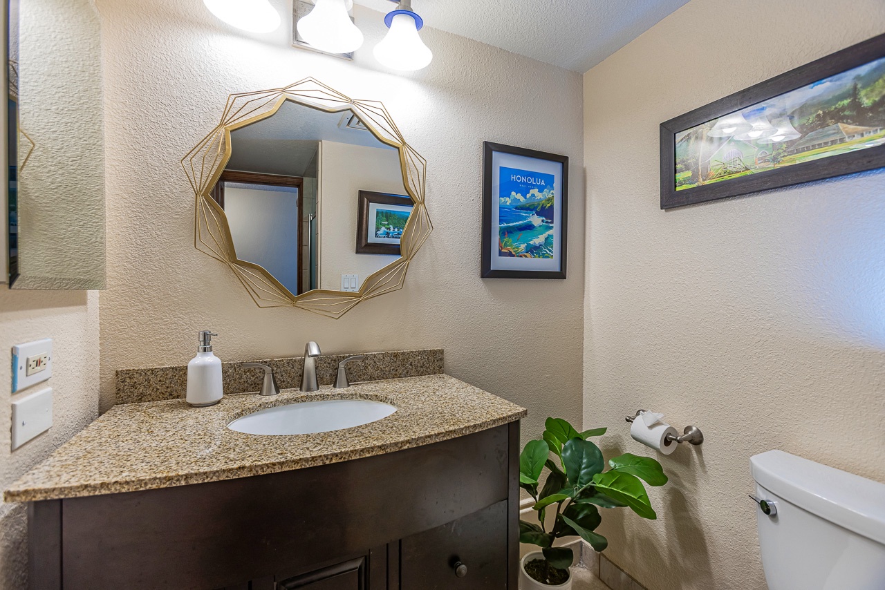 Freshen up in your stylish bathroom with its modern granite vanity, geometric mirror, and tropical touches. Everything you need is right here for a comfortable stay.