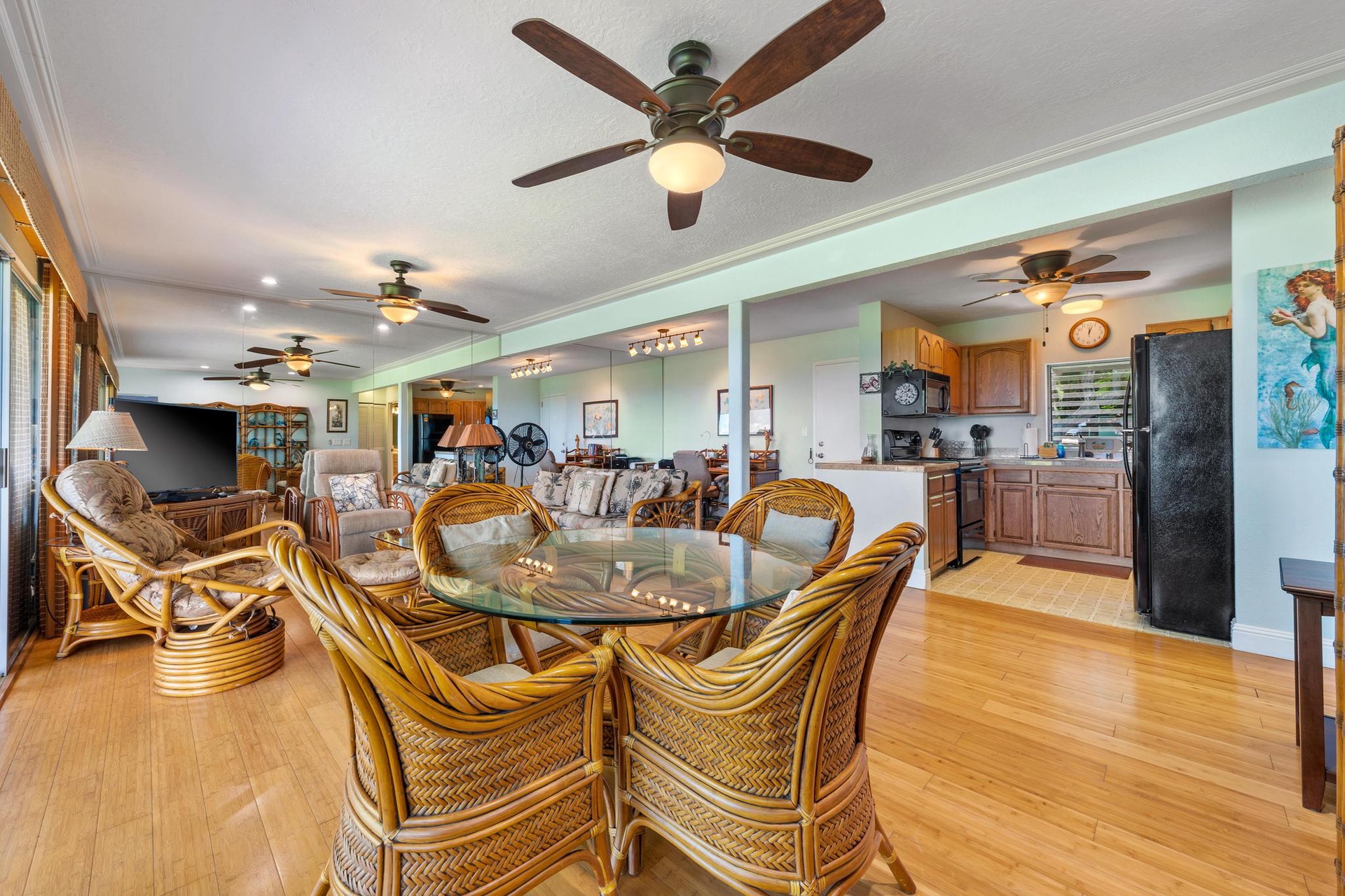 Your tropical-style dining area flows seamlessly into the living room, creating perfect spaces for memorable meals and relaxation.