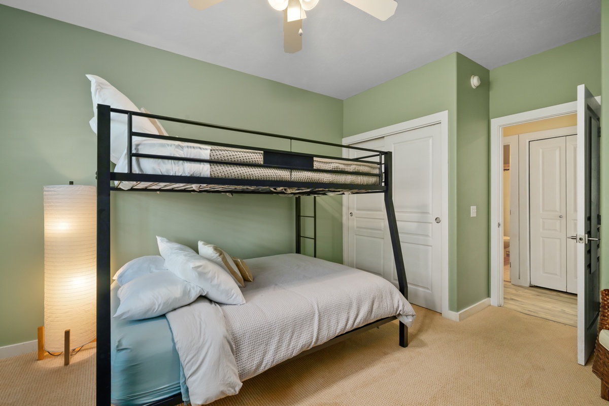 Unwind in your serene bedroom with a stylish bunk bed setup a cozy atmosphere perfect for family stays.