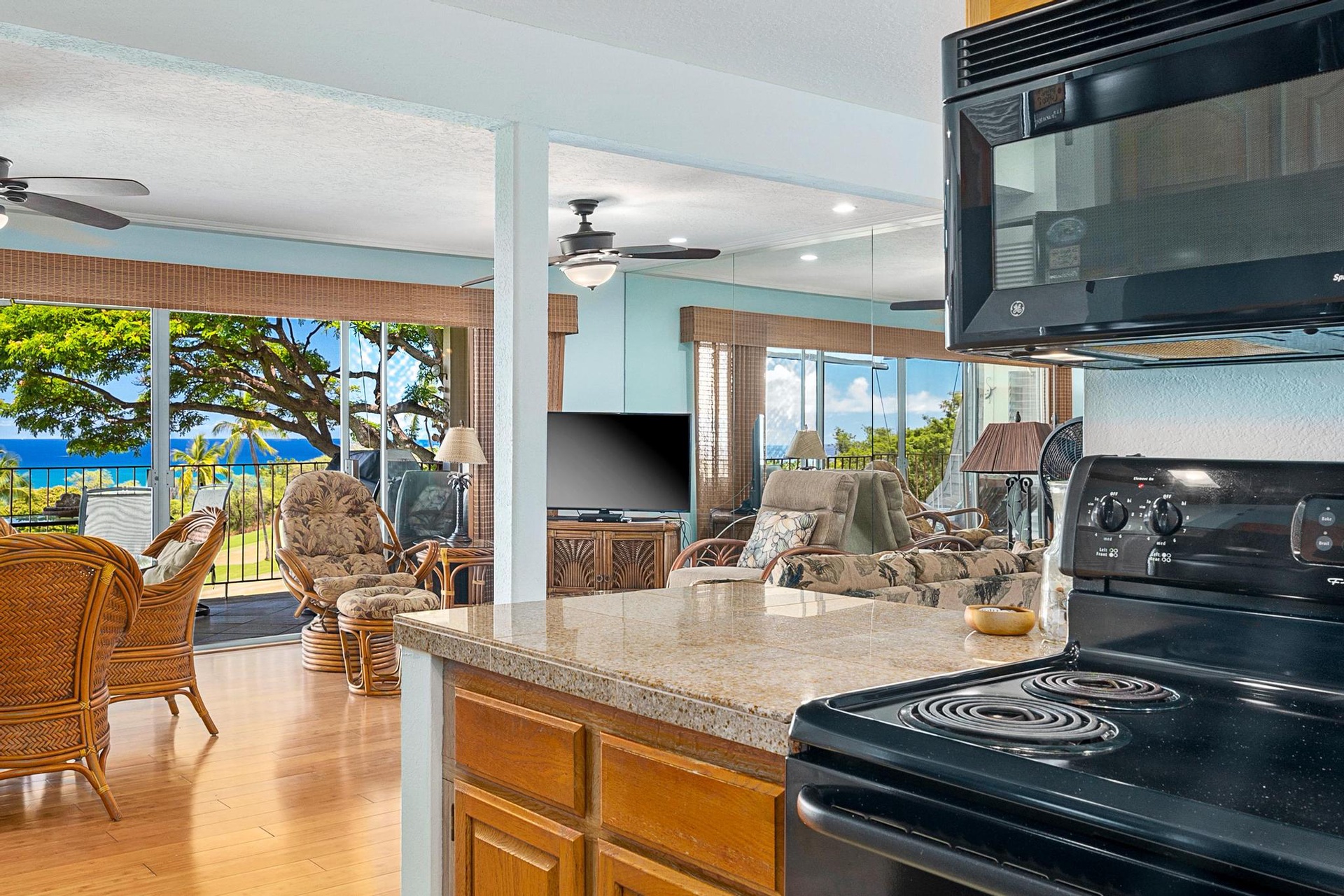 Your open kitchen flows into the living area, where tropical views and ocean breezes create the perfect Hawaiian getaway atmosphere.