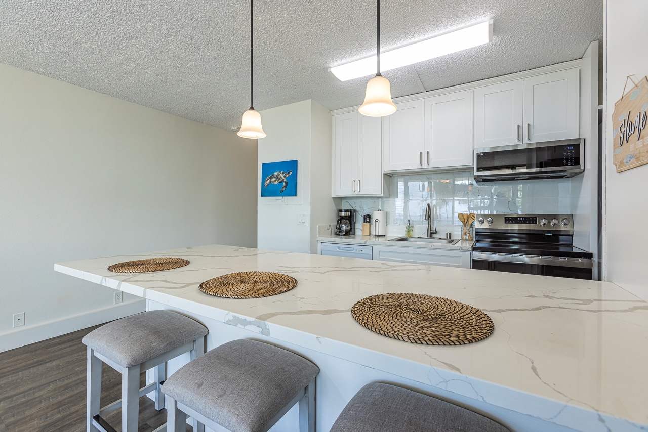 Marble countertops and island decor await in your fully equipped kitchen