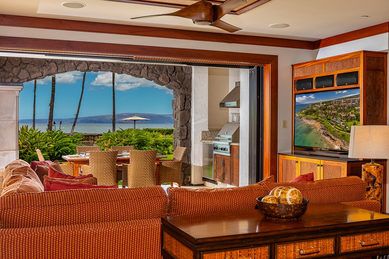 Sink into the woven sofa and take in the breathtaking ocean view framing your outdoor dining area, where island breezes and endless blue waters become part of your everyday retreat.