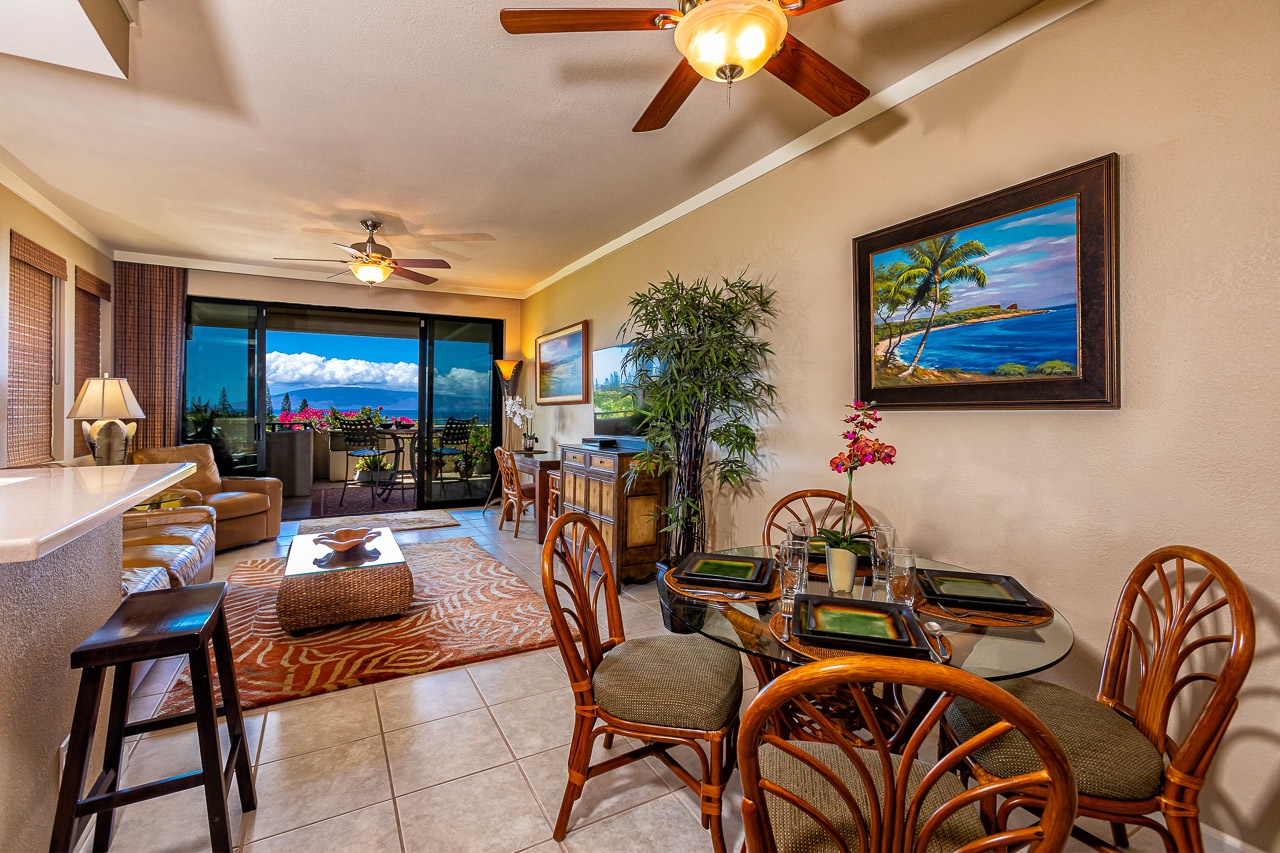 Your inviting open-concept space features tropical decor, comfortable seating, and a dining area where you can enjoy meals with stunning ocean views through expansive sliding doors.