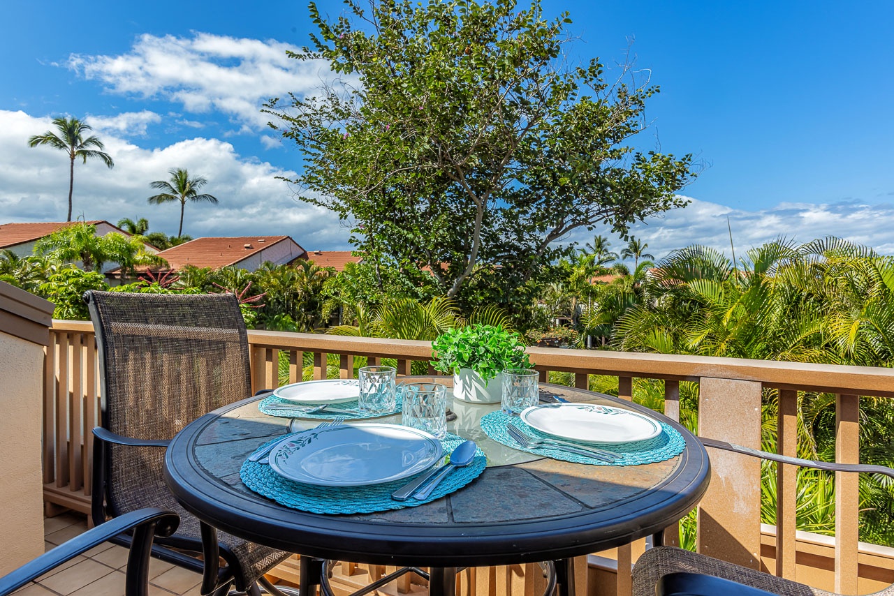 Picture yourself dining al fresco on your private lanai, where turquoise placemats and tropical greenery set the scene for memorable island mornings and evenings surrounded by swaying palms and lush garden views.
