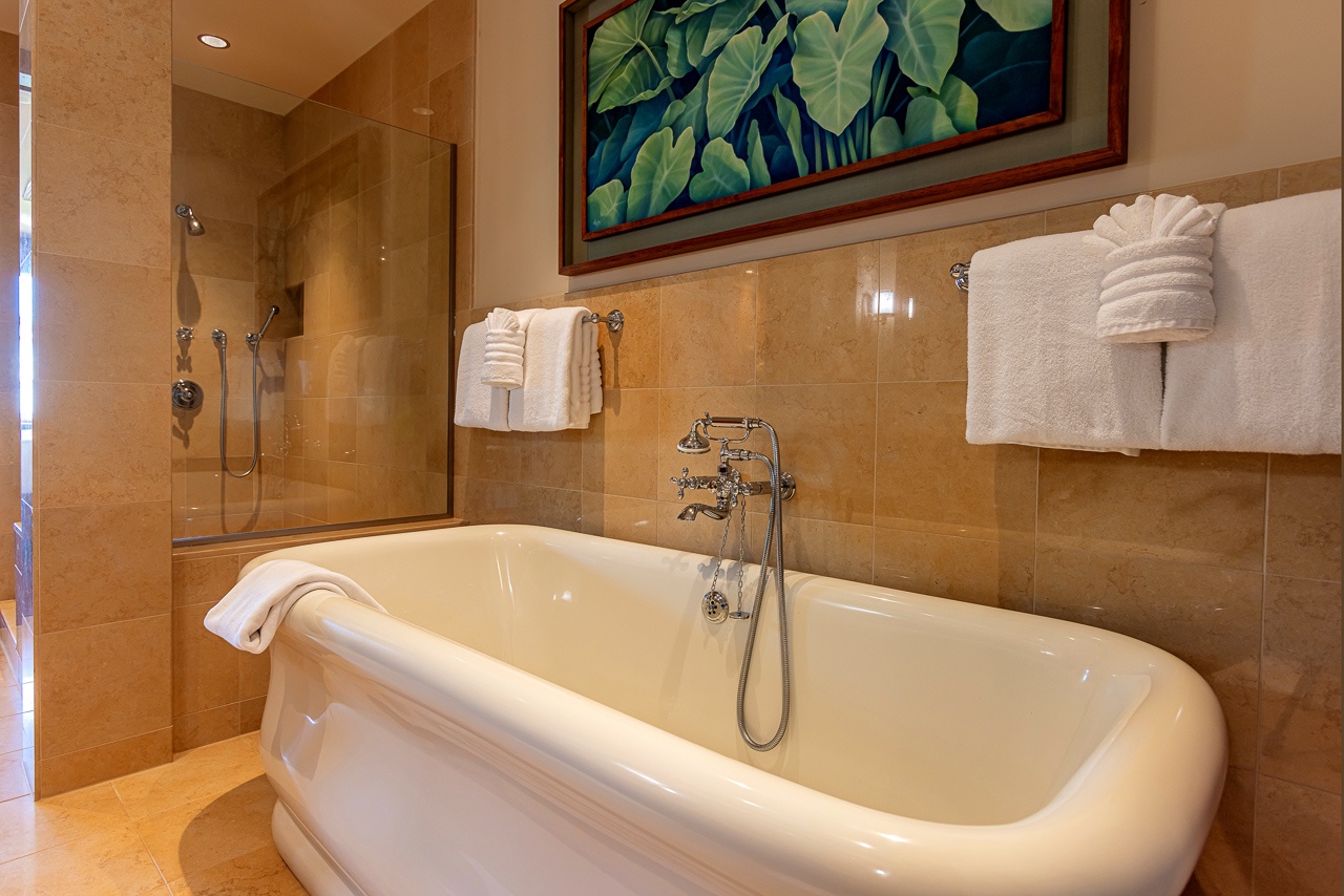 Sink into your private soaking tub surrounded by warm stone and crisp linens—your perfect escape after a day of island exploring.