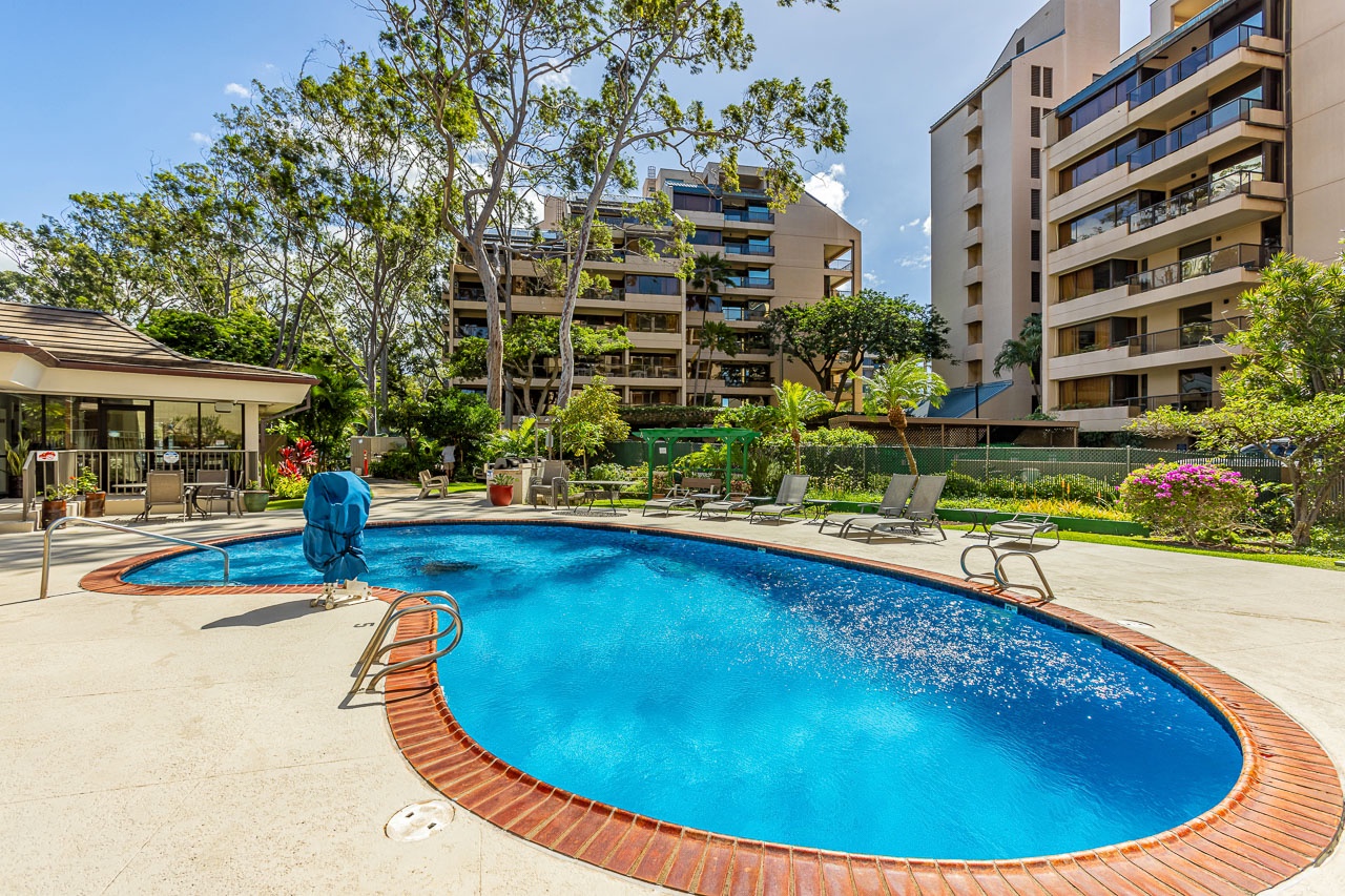 Lounge beside shimmering blue water in a serene tropical setting