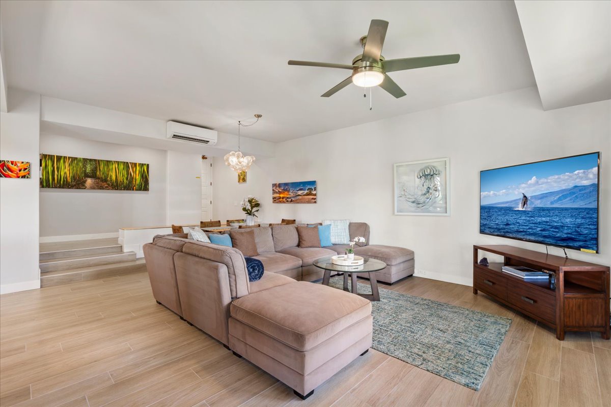Relax in your bright, open living area featuring plush sectional seating, modern décor, and climate-controlled comfort for unwinding after island adventures.