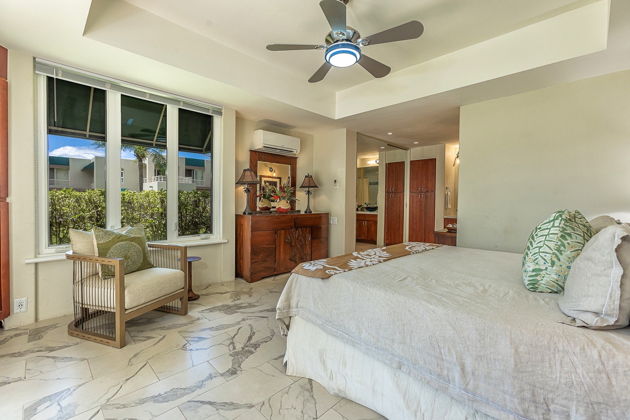 Relax in your serene bedroom retreat with breezy ceiling fan, tropical garden views, and elegant marble floors that lead to your private ensuite.