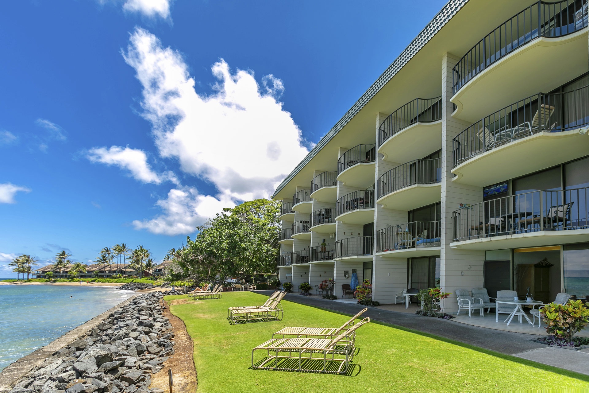 This property sits right on the waterfront, with a lush lawn leading. Each unit opens to its own private balcony.