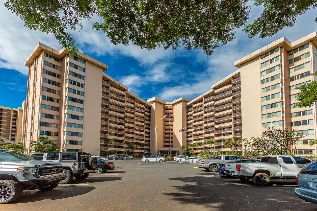 Multi-story beachfront property with convenient on-site parking and mature tropical landscaping in a prime location.