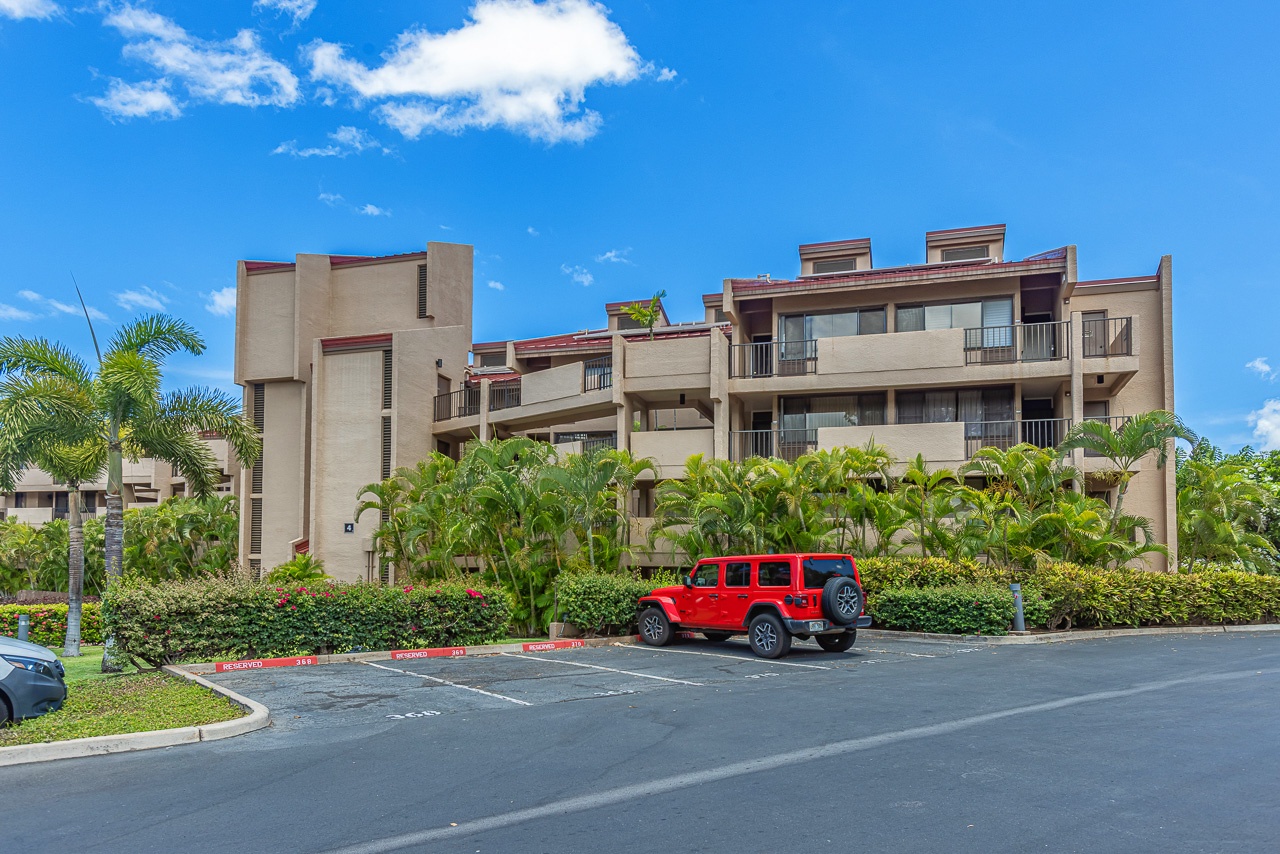 A modern tropical resort complex with landscaped gardens and convenient parking, set under clear blue Caribbean skies.