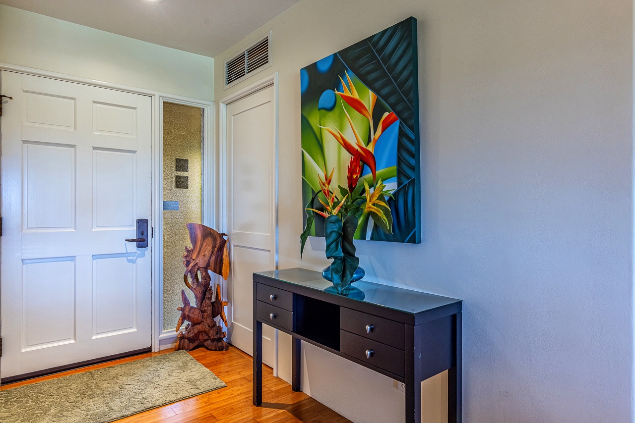 Step inside to find a welcoming entry filled with tropical color and island-inspired art, setting a relaxed, vibrant tone for your entire stay.