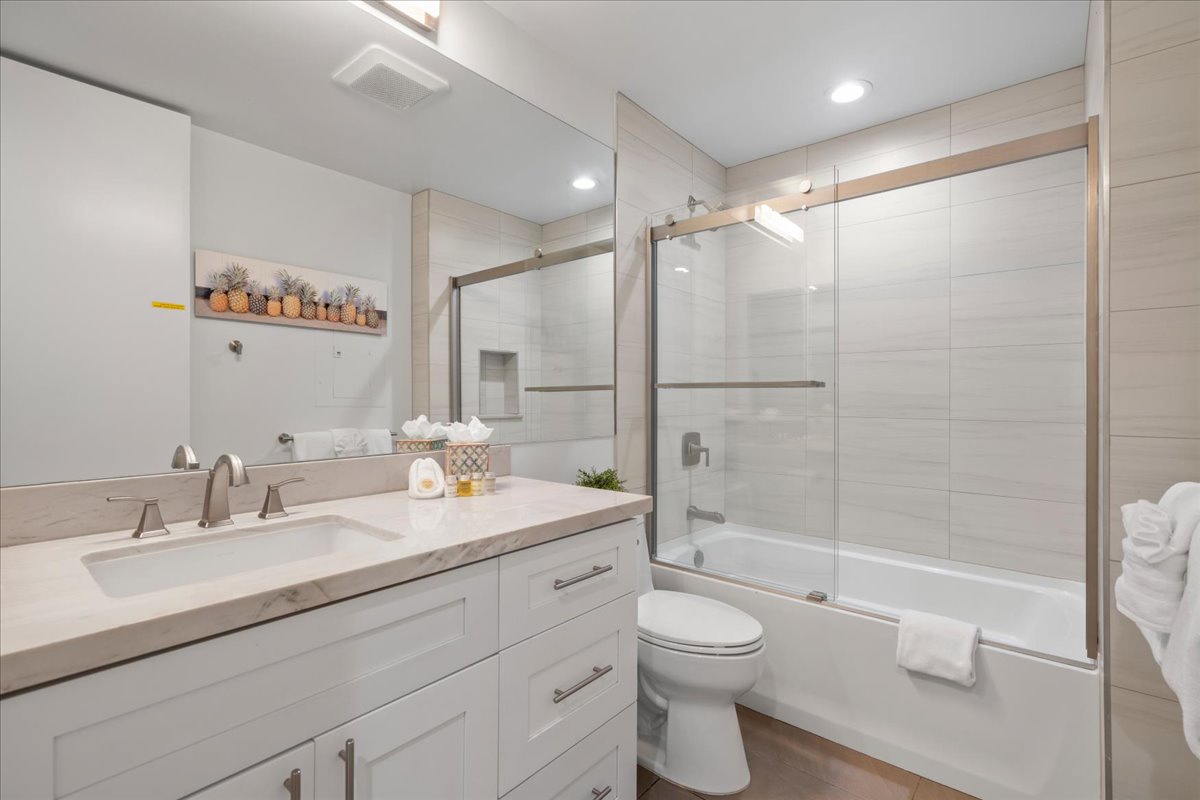 Step into your beautifully appointed bathroom with soft neutral tones and elegant finishes. Fresh towels await your arrival, and the spacious tub and shower combination offers the perfect place to unwind after a day of exploring.