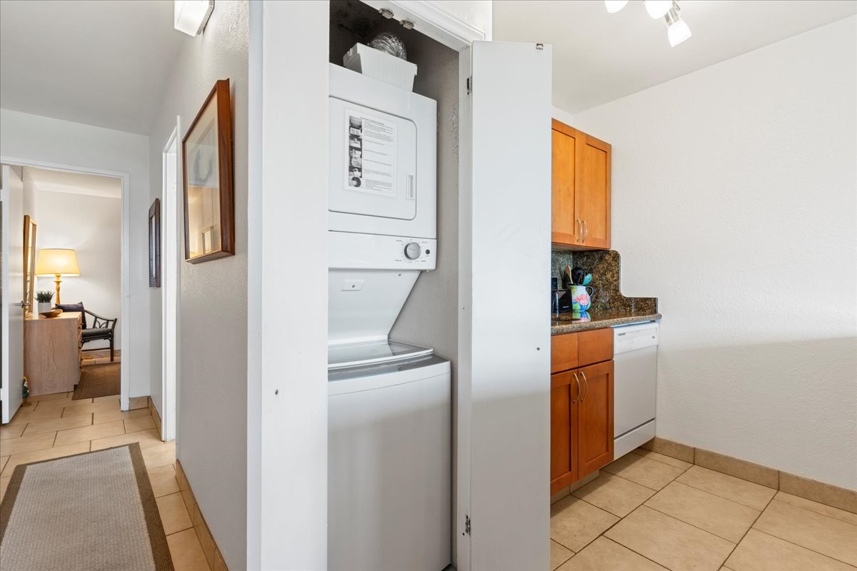 Your kitchen area features warm wood cabinetry and granite countertops, plus the convenience of in-unit laundry to keep your vacation wardrobe fresh.