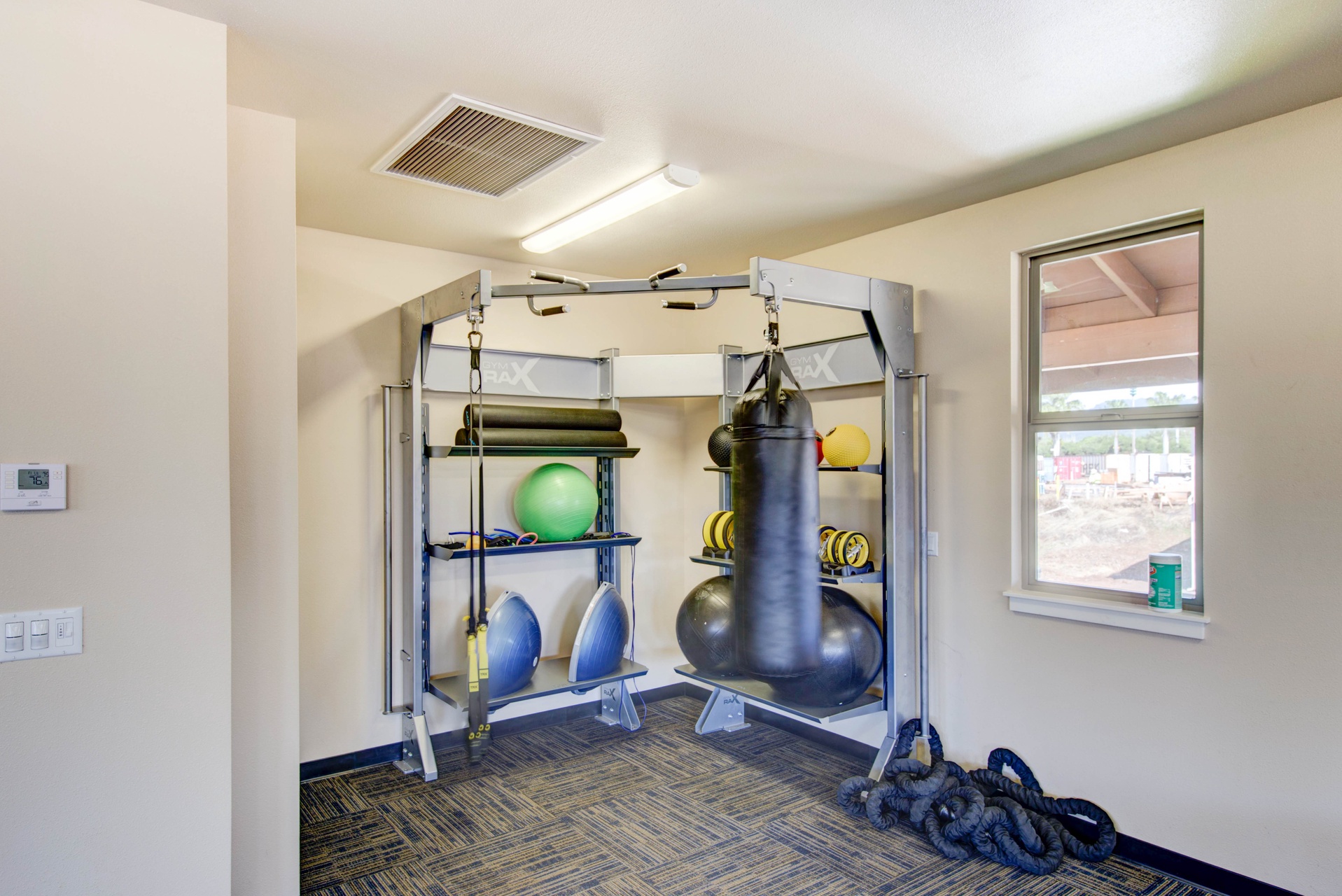 Fitness room with professional equipment, perfect for maintaining your workout routine during your stay.