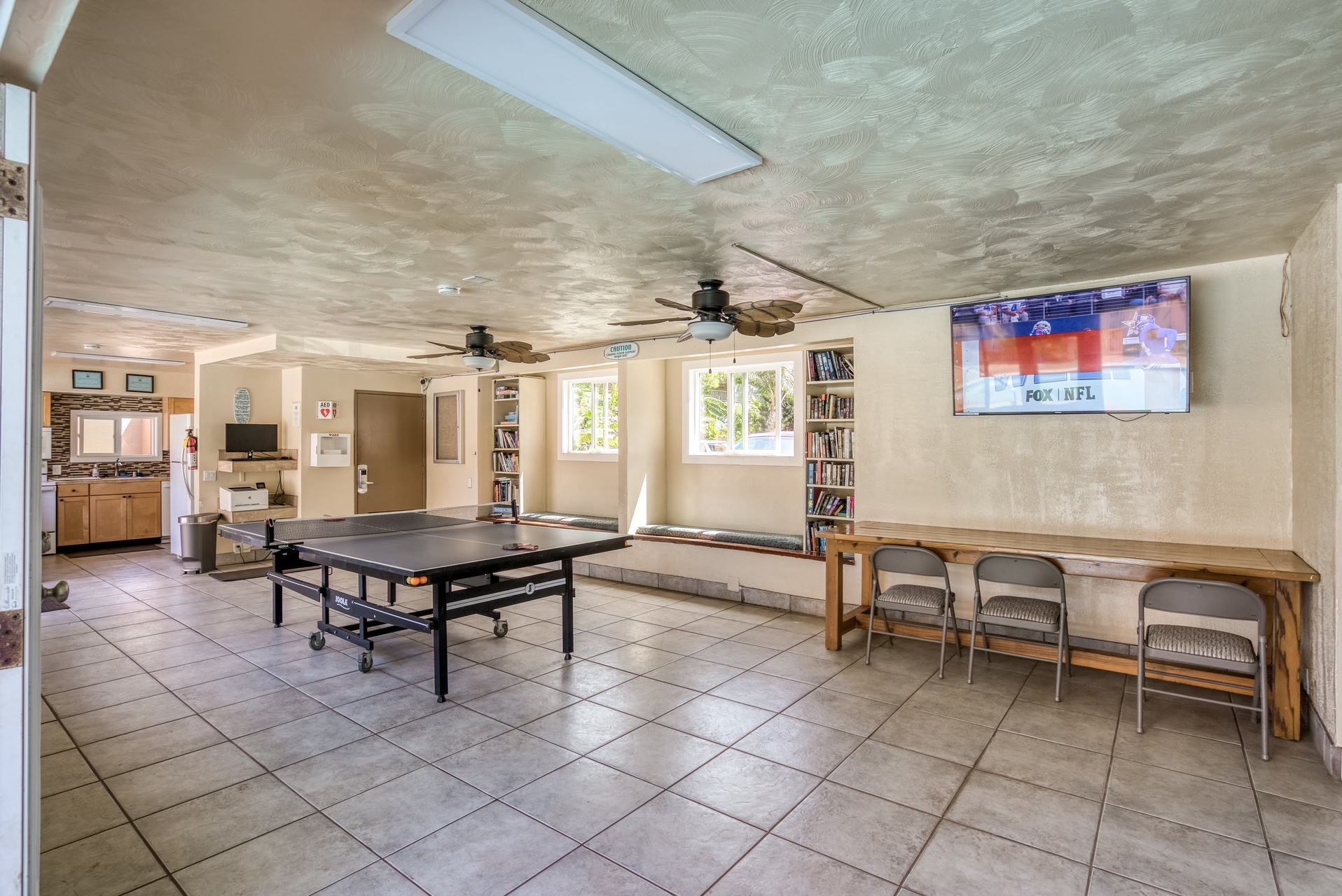 Challenge a friend to table tennis or unwind with a book from the shelves in this bright communal game room with seating and a large screen for your favorite shows.