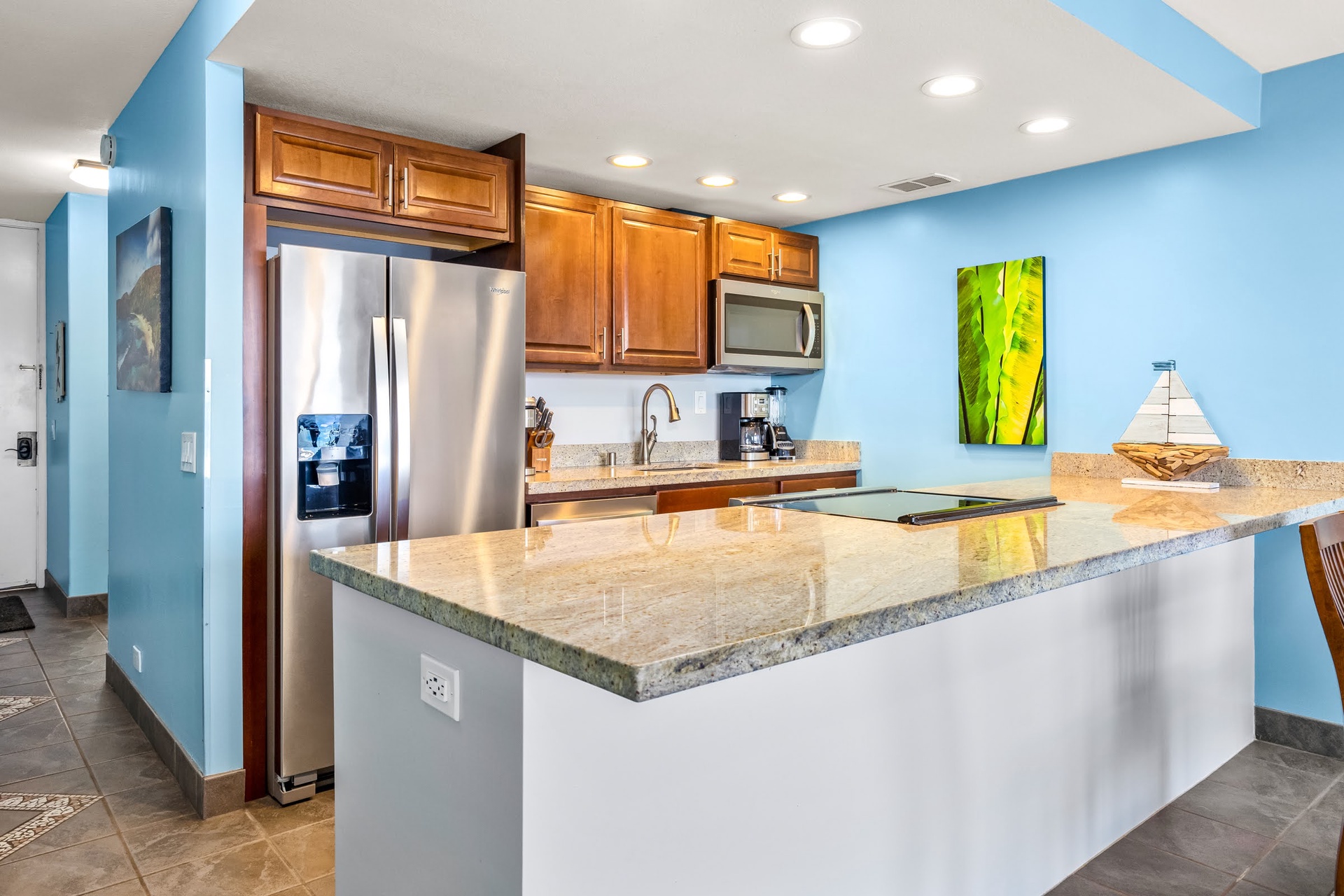 Your fully equipped kitchen features gleaming granite countertops, stainless steel appliances, and a spacious breakfast bar perfect for morning coffee or casual meals with family.