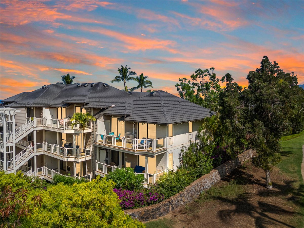 Tropical paradise property nestled among palms and lush greenery, framed by stunning sunset hues painting the evening sky—your serene island retreat awaits.